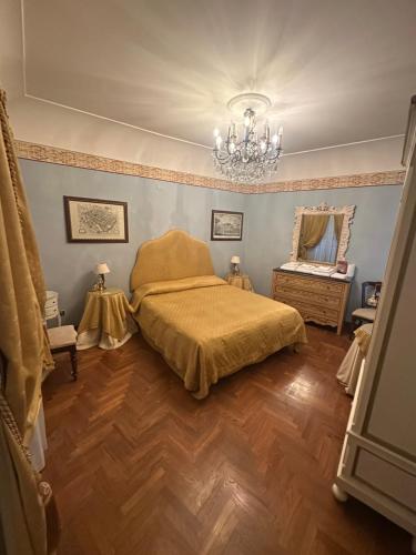 a bedroom with a bed and a chandelier at B&B La Porticella in Viterbo