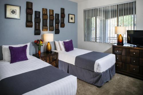 a hotel room with two beds and a television at Luxury Condos by Meridian CondoResorts- Scottsdale in Scottsdale