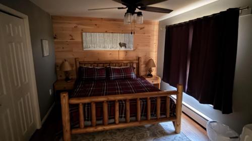 a bedroom with a bed with a wooden wall at Lies by AvantStay in North Creek