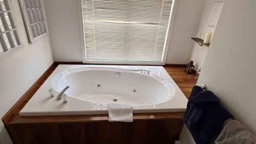 a white bath tub in a bathroom with a window at Lies by AvantStay in North Creek