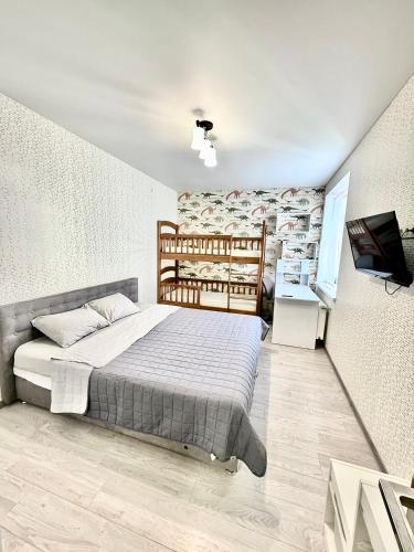 a bedroom with a bed and a television in it at Apartment Synergia 3 in Irpin