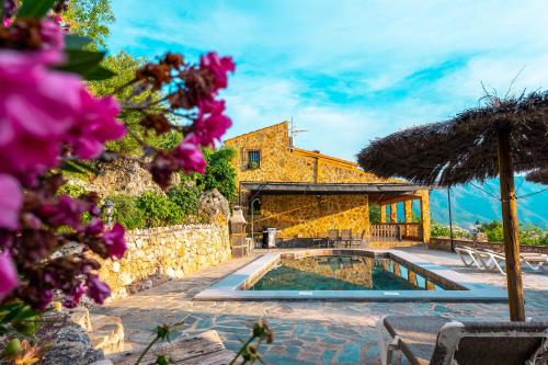 a villa with a swimming pool and a building at El Valle Dorado in El Gastor