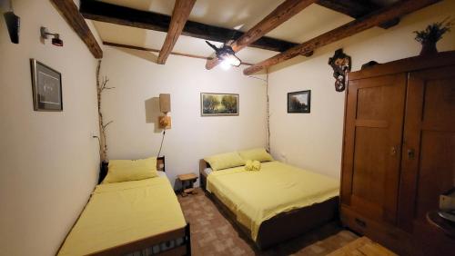 a bedroom with two beds and a cabinet at Ciconia Nigra rooms in Bački Monoštor
