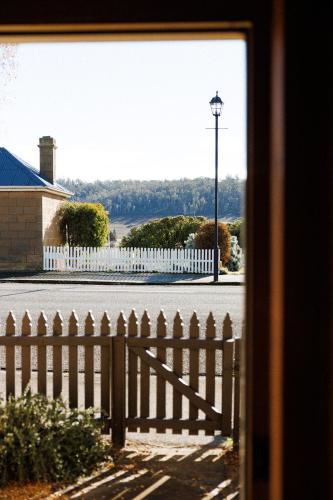 a view of a fence and a street with a light pole at 101 Oatlands Tasmania in Oatlands
