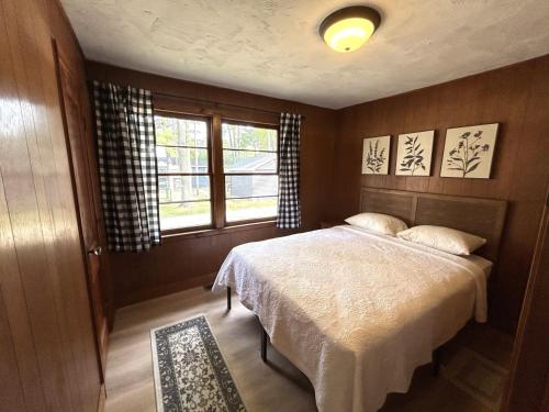 a bedroom with a bed and a window at Hidden Haven Cottages in Lake City
