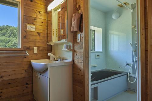 a bathroom with a sink and a bath tub at Koguchi Village by WhyKumano in Shingū