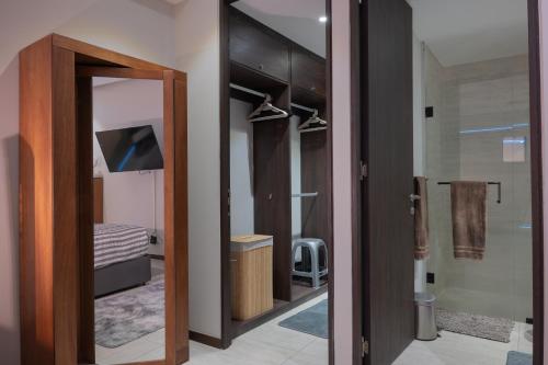 a bathroom with a glass door and a mirror at Condo in Bucerías Beachfront Narval Norte in Bucerías