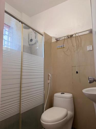a bathroom with a shower and a toilet and a sink at Casa Saturnino Private Staycation 