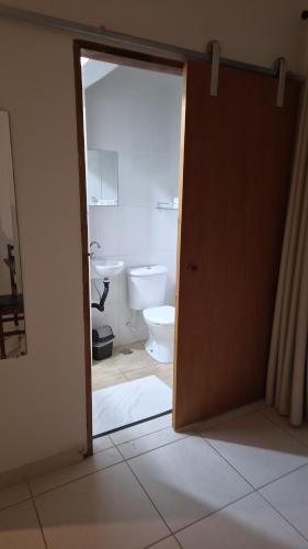 an open door to a bathroom with a toilet at Hotel Flamboyant Taubate in Taubaté