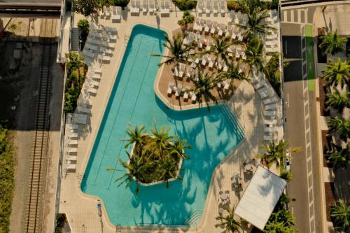 an overhead view of a pool at a resort at Miami Luxe Sky 27 Skyline View Stunning Water & City Lights View, Resort Pool,Gym,Spa Restaurants in Miami