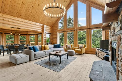 a living room with a couch and a table at Fiddler Lake Resort - Deer 87 in Mille-Isles
