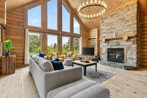 a living room with a couch and a fireplace at Fiddler Lake Resort - Deer 87 in Mille-Isles