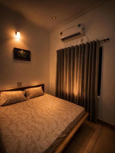 a bedroom with a bed and a window with a heater at The Golden Window Villa in Amritsar