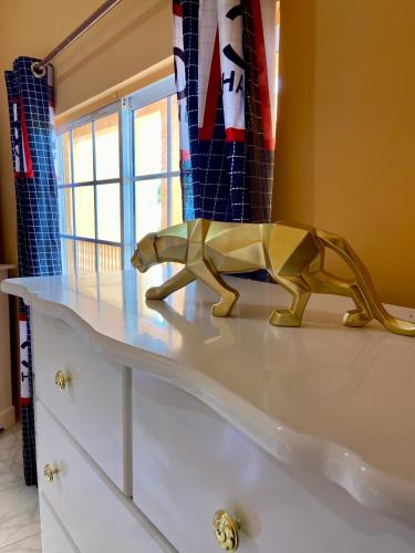 a wooden dog toy on top of a dresser at Vista Oceanica in Ocho Rios