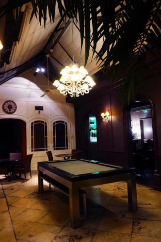 a ping pong table in a room with a chandelier at LOGIS Hôtel de Bourgogne - Mâcon in Mâcon