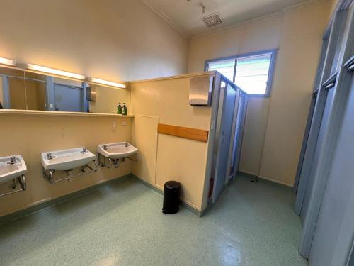 a public bathroom with two sinks and a mirror at The Leopold Hotel in Ararat