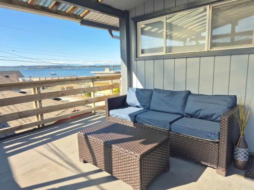 a wicker couch sitting on the porch of a house at 2nd Floor Studio #4 with Ocean View and Covered Deck in Blaine