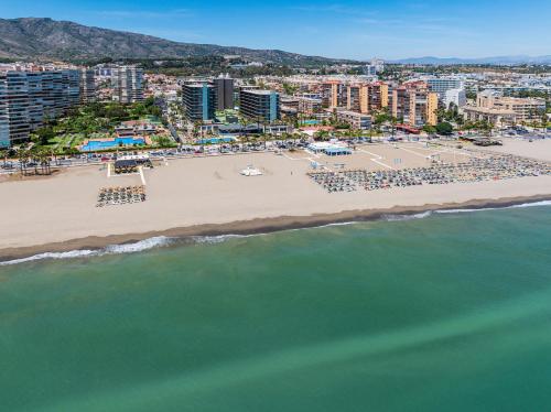 an aerial view of a beach with buildings and the ocean at SOL by Meliá Príncipe in Torremolinos