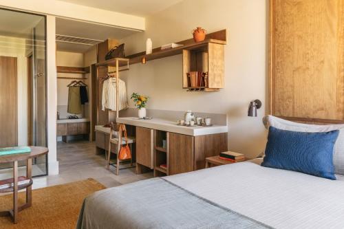a bedroom with a bed and a bathroom with a sink at ME by Meliá Malaga in Málaga