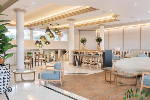 a rendering of a hotel lobby with tables and chairs at SOL by Meliá Sun Beach Apartamentos in Adeje