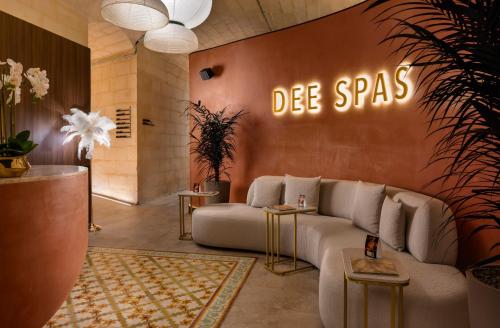 a living room with a couch and a sign that reads die spaces at ME by Meliá Malta in St. Julianʼs