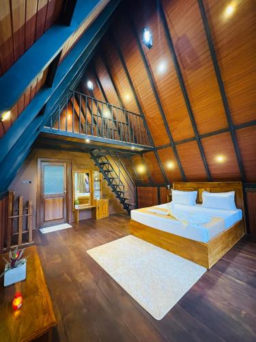 a bedroom with a large bed and a staircase at Arcadiaa Cabana in Polonnaruwa