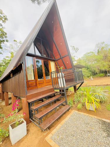 a small house with a staircase leading to it at Arcadiaa Cabana in Polonnaruwa
