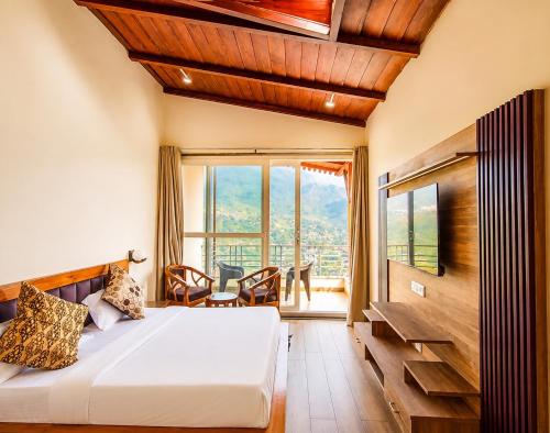 a bedroom with a bed and a large window at The Shantii Boho in Bhīm Tāl
