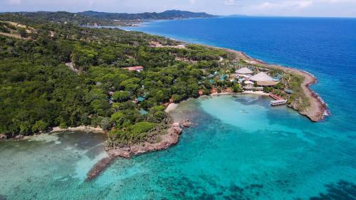 an aerial view of an island in the ocean at Hotel Roatán Media Luna Resort, Affiliated by Meliá in First Bight