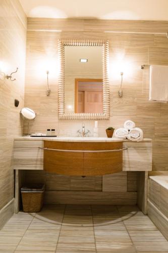 a bathroom with a sink and a mirror at Mainalon Resort in Tripoli
