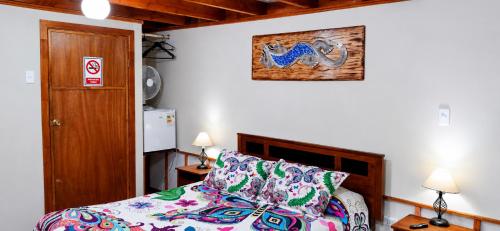 a bedroom with a bed and a picture on the wall at Apart Hotel Caldera - Room in Caldera