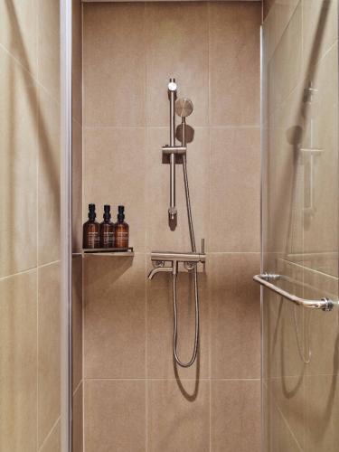 a bathroom with a shower with a glass door at Seoul ABC Hostel in Seoul