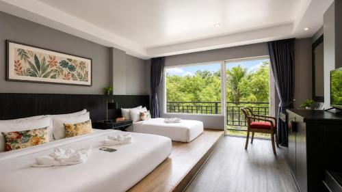 a hotel room with two beds and a balcony at JALMIN Hotel Samui in Chaweng