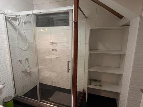 a bathroom with a shower and a sink at Casa Munay in Huancayo
