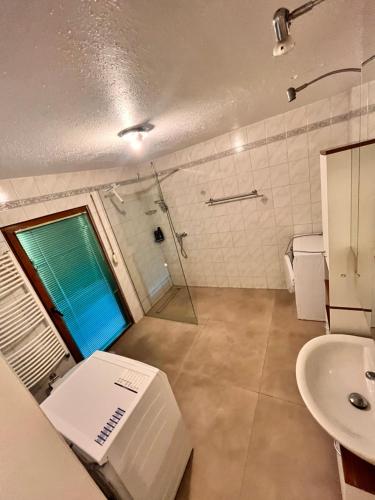 a bathroom with a sink and a shower and a toilet at Zimmer heilbronn in Heilbronn