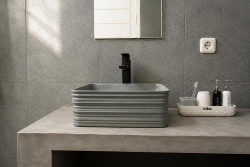 a sink with a faucet on a counter in a bathroom at Tropical Villa with Swimming Pool in Selong Belanak