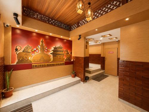 a hotel lobby with a sign on the wall at Hotel Kesu Home in Kathmandu