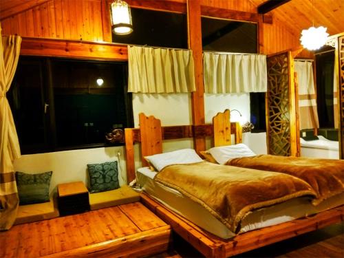 a bedroom with a large bed in a room at Lijiang Baisha Free Time Designed Hotel in Lijiang