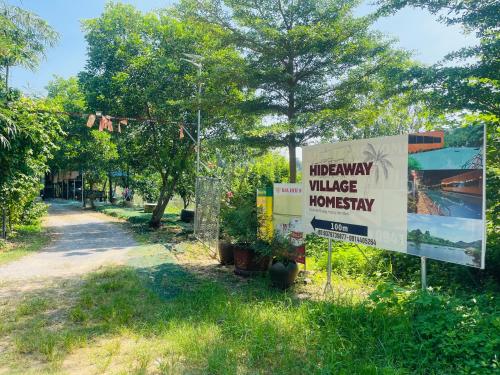 a sign for the university village of hominy at Hideaway Village Homestay in Xuân Sơn