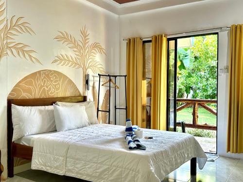 a bedroom with a bed and a sliding glass door at Villa Consolacion Resort in General Luna