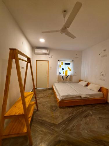 a bedroom with a bed and a ladder in it at Horn Ok Please Hostel Mandrem in Mandrem