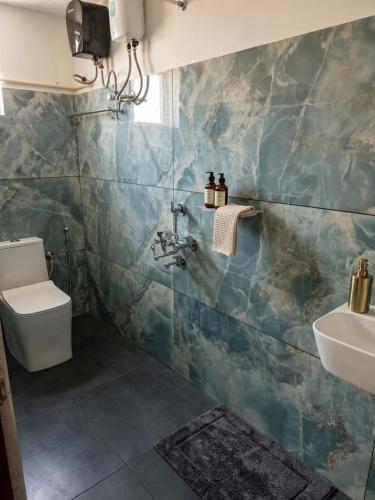 a bathroom with a sink and a toilet at Tranquil Tents in Trivandrum
