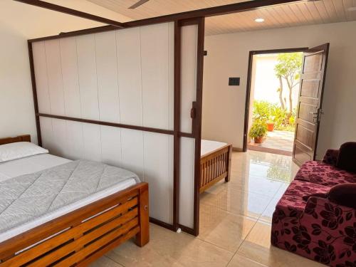 a bedroom with a bed and a sliding glass door at Tranquil Tents in Trivandrum