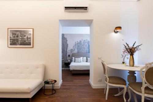 a living room with a couch and a table at Palazzo del Poeta - Dimora Contemporanea in Palermo
