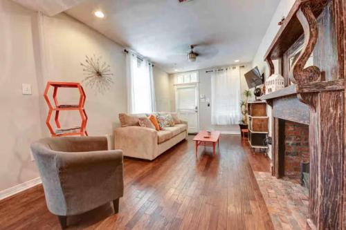 a living room with a couch and a fireplace at Steps into the French Quarter in New Orleans