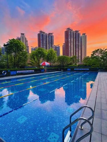 a swimming pool with a city skyline in the background at Ruilan Courtyard in Shenzhen