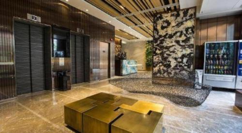 a lobby with a table in the middle of a room at Ehotel in Hong Kong