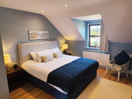 a bedroom with a bed and a chair in it at Radharc Sléibhe in Kilgarvan