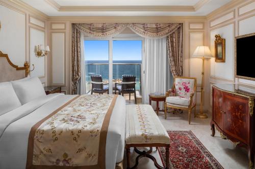 a bedroom with a large bed and a large window at Hilton Alexandria Corniche Hotel in Alexandria
