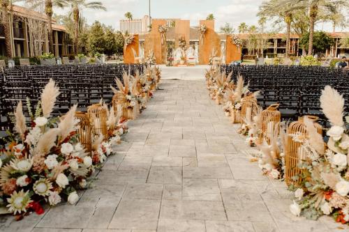 an aisle with chairs and flowers at a wedding at DoubleTree by Hilton Orlando Theme Park Resort in Orlando